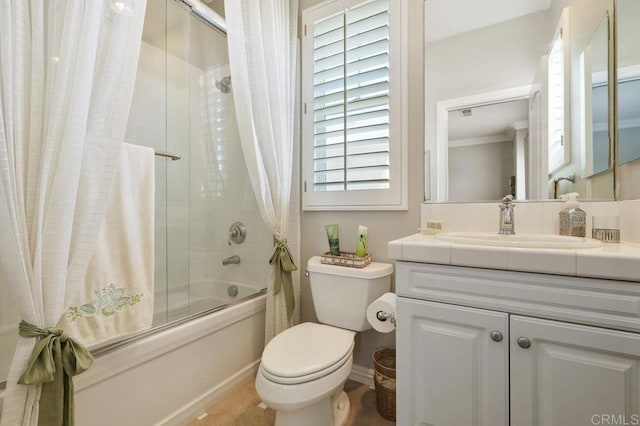 bathroom with toilet, combined bath / shower with glass door, and vanity