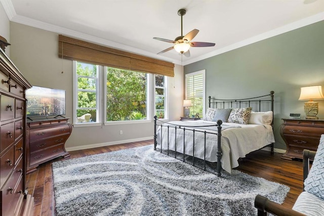 bedroom with ornamental molding, wood finished floors, a ceiling fan, and baseboards