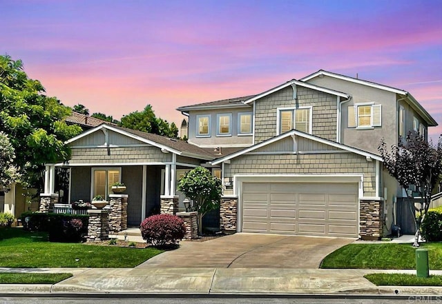 craftsman house with a porch, concrete driveway, an attached garage, and stone siding