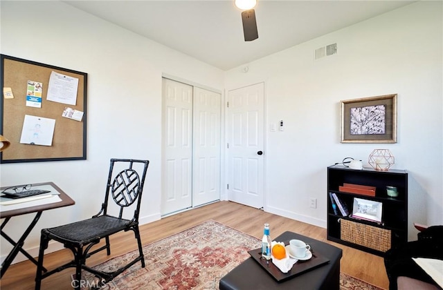 home office with hardwood / wood-style flooring and ceiling fan