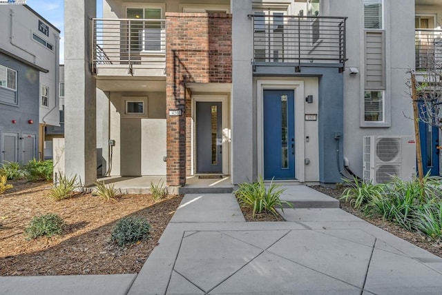 doorway to property with a balcony and ac unit