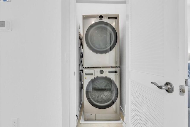 laundry room with stacked washer and dryer