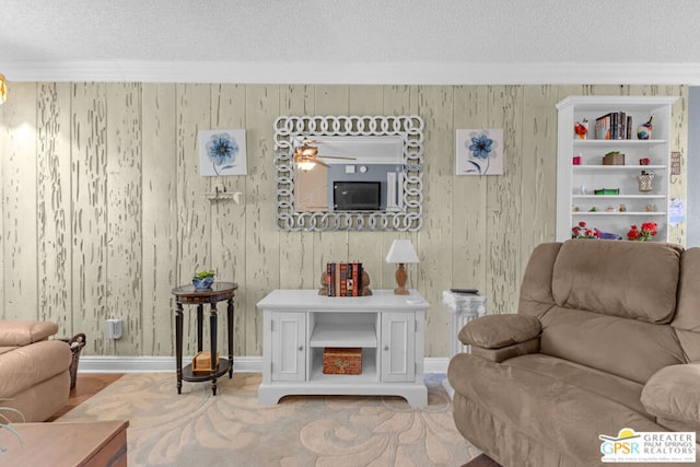 living room with crown molding, built in features, and a textured ceiling