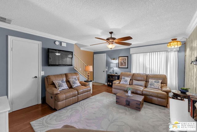 living room featuring crown molding, ceiling fan, a textured ceiling, and light hardwood / wood-style floors