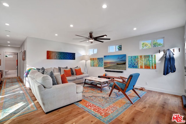 living room with ceiling fan and light hardwood / wood-style floors