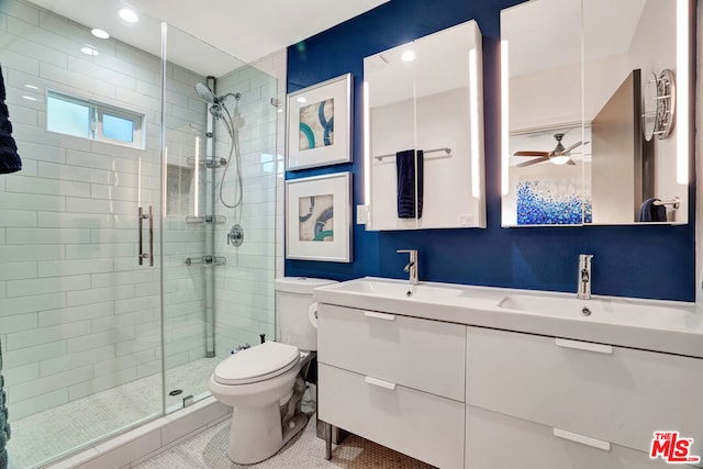 bathroom with tile patterned flooring, vanity, walk in shower, and toilet