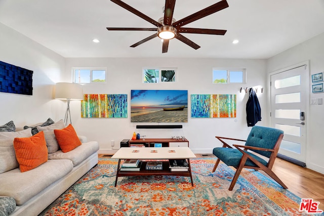 living room featuring ceiling fan and light wood-type flooring