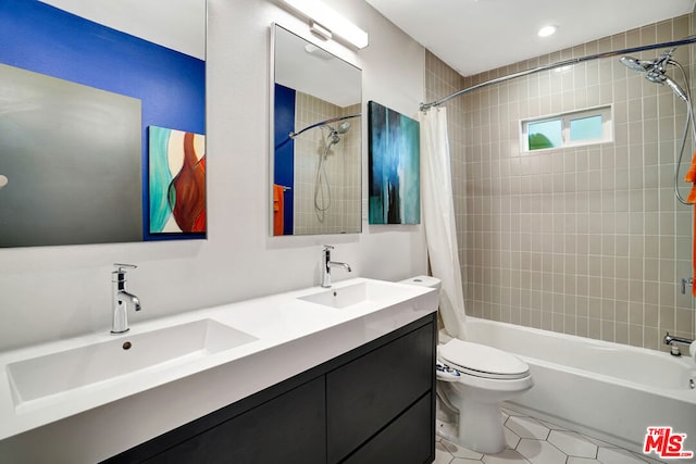 full bathroom featuring tile patterned floors, toilet, vanity, and shower / bath combo