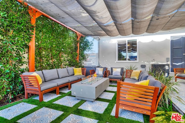 view of patio / terrace with an outdoor living space with a fire pit and a pergola