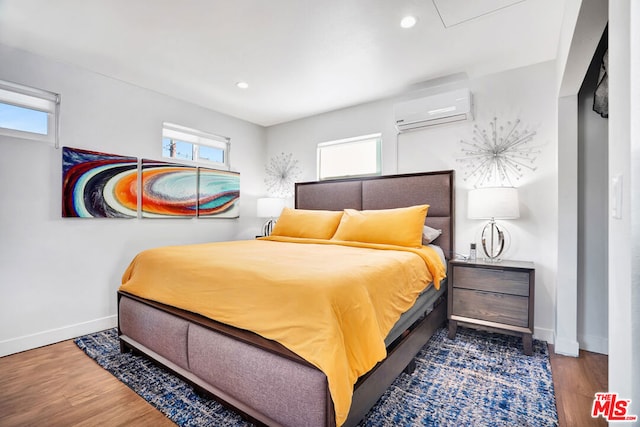 bedroom with dark hardwood / wood-style flooring and a wall mounted air conditioner