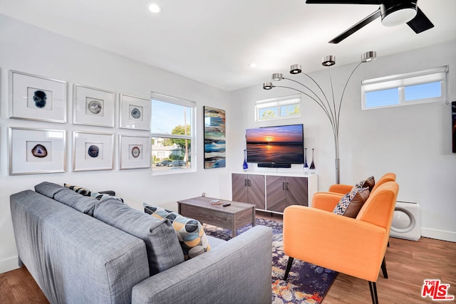 living room with hardwood / wood-style floors, a wealth of natural light, and ceiling fan