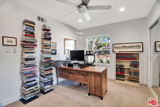 carpeted office featuring ceiling fan