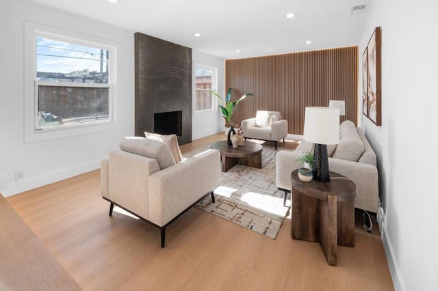 living room with a fireplace and light hardwood / wood-style flooring