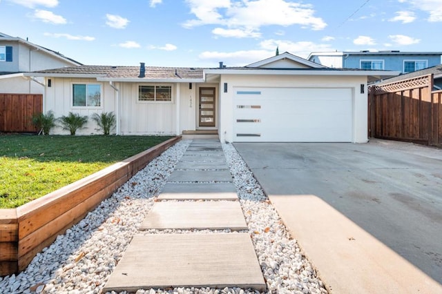 ranch-style house featuring a garage and a front lawn