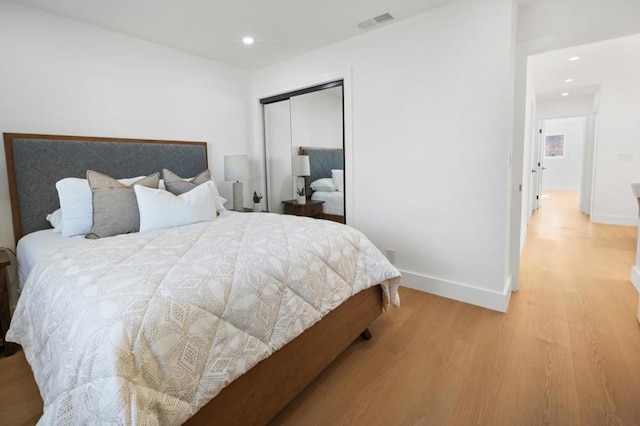 bedroom featuring light wood-type flooring and a closet