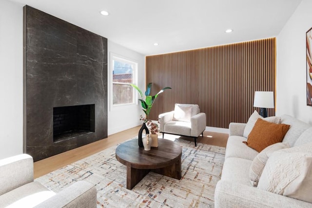 living room with light hardwood / wood-style flooring and a premium fireplace