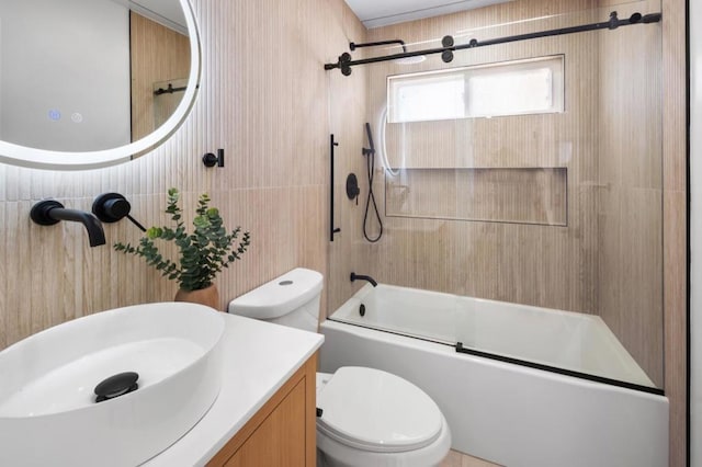 full bathroom featuring bath / shower combo with glass door, vanity, and toilet