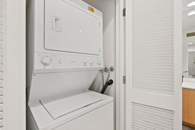 laundry area featuring stacked washer and clothes dryer