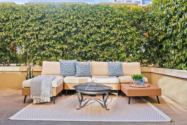 view of patio / terrace with an outdoor living space with a fire pit