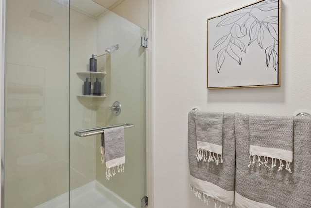 bathroom featuring a shower with door