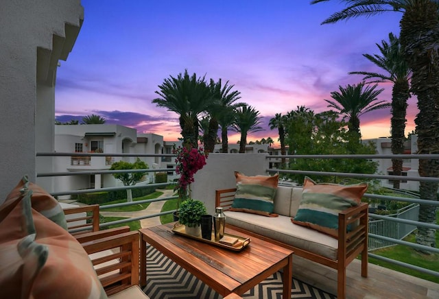 balcony at dusk featuring an outdoor hangout area