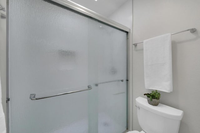 bathroom featuring toilet and walk in shower