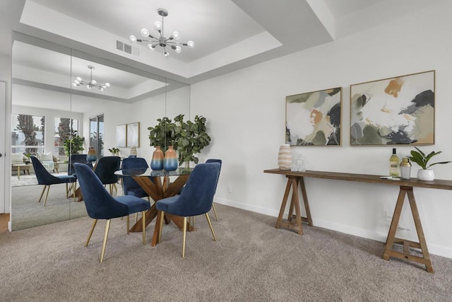 carpeted dining area with a raised ceiling and a notable chandelier