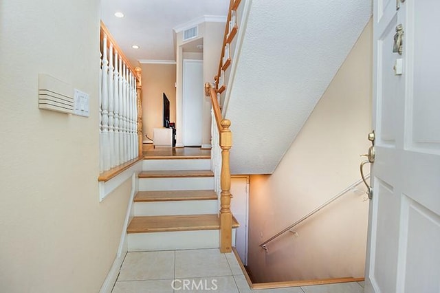 staircase with visible vents, baseboards, tile patterned floors, ornamental molding, and recessed lighting