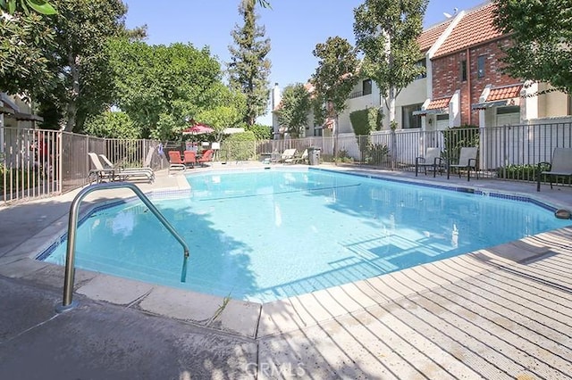pool featuring a patio area and fence