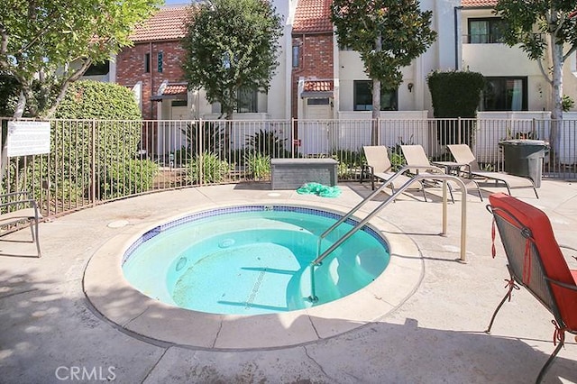 view of pool with a hot tub and a patio