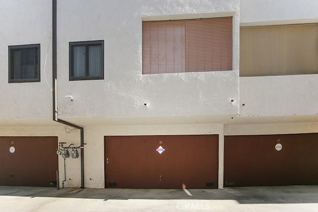 back of property featuring stucco siding