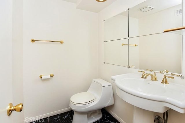 bathroom with sink and toilet