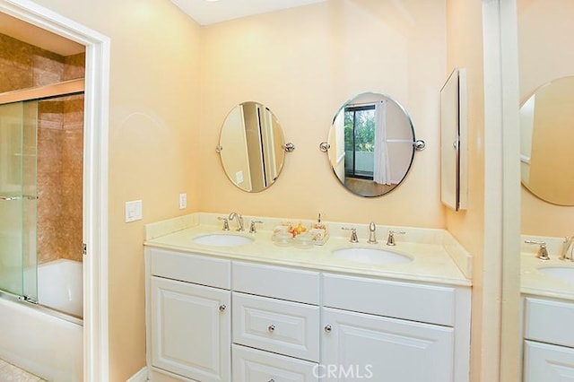 bathroom featuring vanity and shower / bath combination with glass door