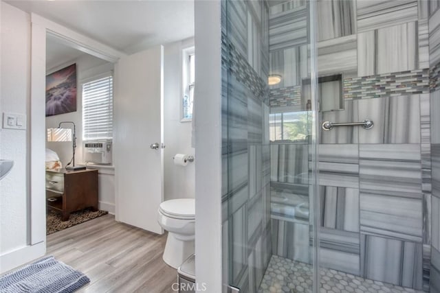 bathroom featuring hardwood / wood-style flooring, cooling unit, and toilet