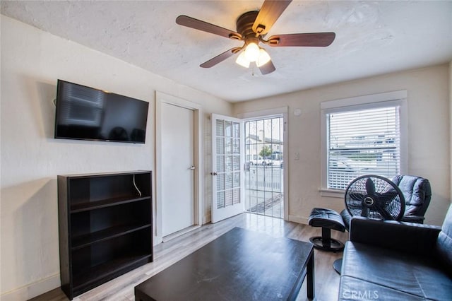 living room featuring ceiling fan and light wood-type flooring