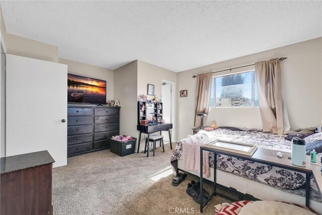 carpeted bedroom featuring a textured ceiling