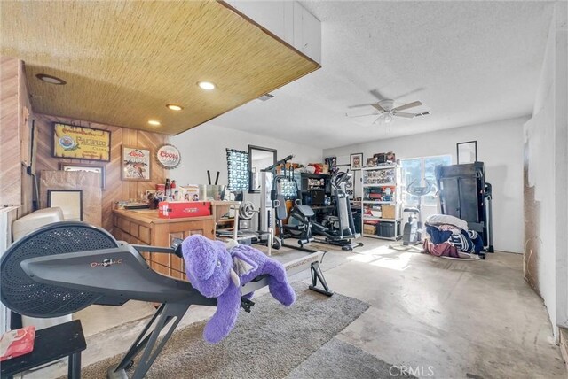 workout room featuring a textured ceiling, plenty of natural light, and ceiling fan