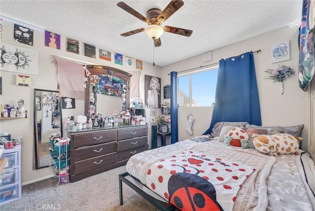 carpeted bedroom with a textured ceiling and ceiling fan