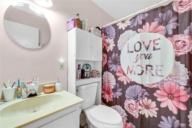 bathroom featuring vanity and toilet