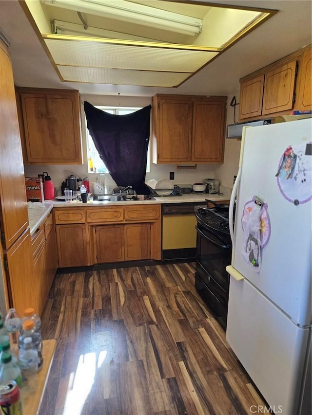 kitchen featuring dark hardwood / wood-style flooring, sink, and white appliances