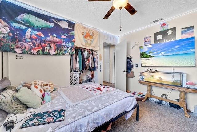 bedroom featuring carpet, a textured ceiling, and ceiling fan