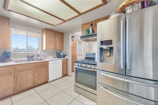 kitchen with stainless steel appliances, light tile patterned flooring, and sink