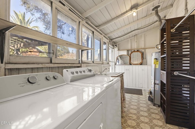 laundry area with gas water heater, sink, wood ceiling, and independent washer and dryer