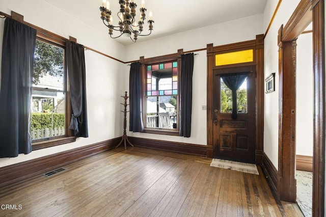 interior space with a notable chandelier and wood-type flooring