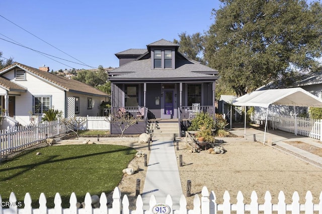 bungalow featuring a carport, covered porch, and a front yard