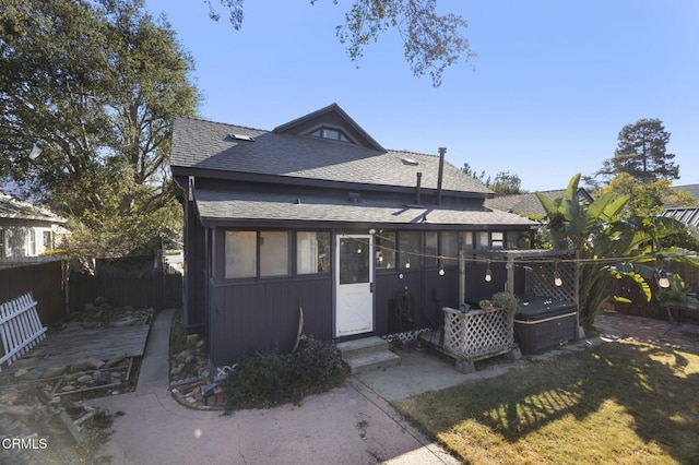 view of front facade with a jacuzzi, a patio area, and a front yard