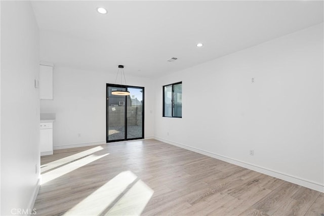 unfurnished room with light hardwood / wood-style floors