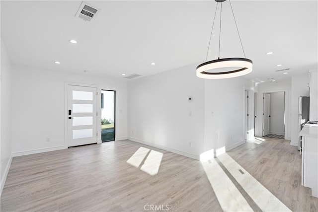 spare room featuring light hardwood / wood-style flooring