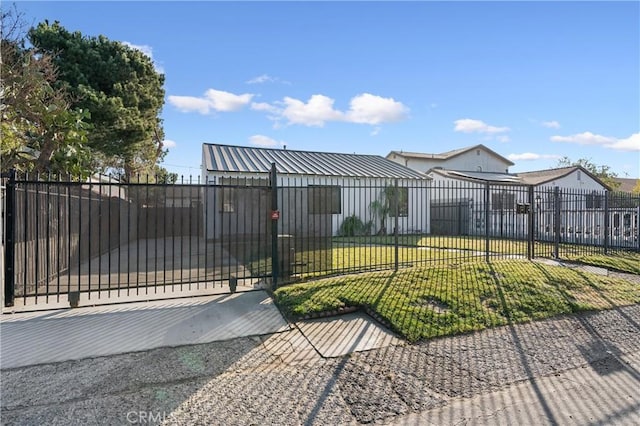 view of gate with a yard