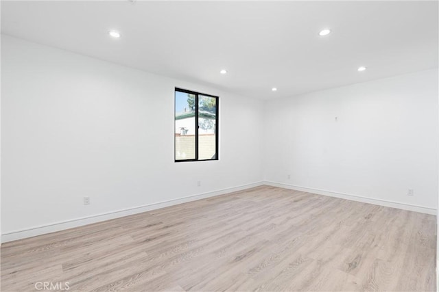 empty room with light hardwood / wood-style flooring